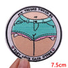 A round embroidered patch featuring a stylized depiction of thighs and the text They love each other