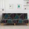 A dark teal and black geometric print spandex slipcover on a sofa bed with framed artwork above it.