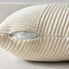 A cream-colored, vertically ribbed textured fabric throw pillow cover is shown in a close-up view.