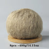 A ball of light beige mohair yarn used for crafting.