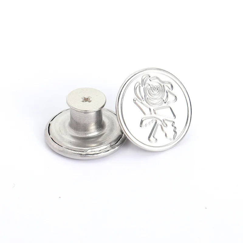 Silver metal button with a rose design relief on the face