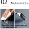 A hand wipes a silver fork with a white cloth, demonstrating the product's ease of cleaning and scratch resistance.