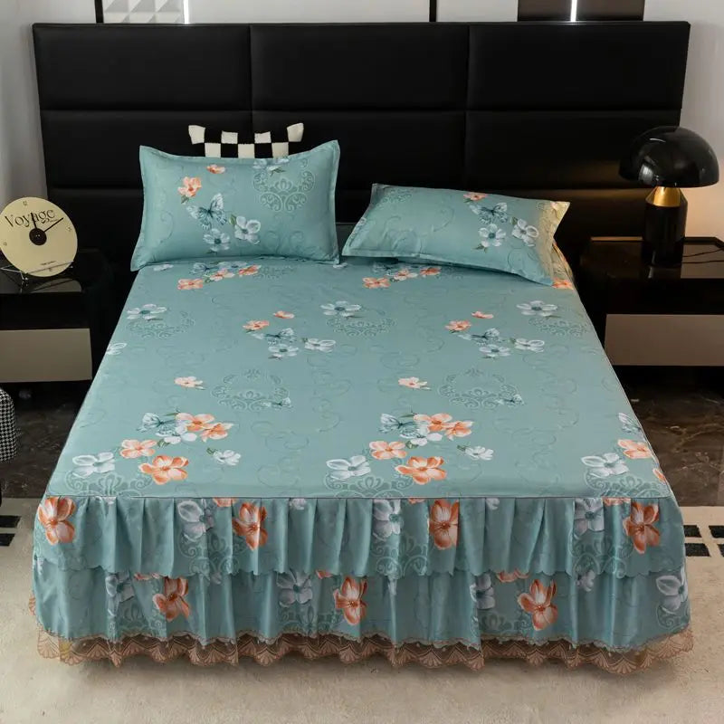 Light blue floral bed skirt protecting a mattress on a dark bed frame.