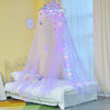 A purple decorative mosquito net bed curtain with sparkling lights draped over a white bed.