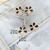 Silver adjustable buckle pants waist tighteners featuring floral-shaped metal clasps