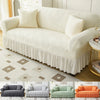 A collection of three upholstered sofas in various colors and fabrics with ruffled skirts.