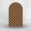 A tall, arched fabric backdrop cover with a brown color and white polka dots.