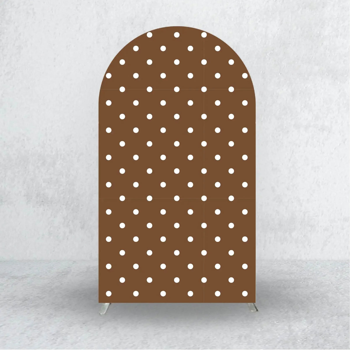A tall, arched fabric backdrop cover with a brown color and white polka dots.