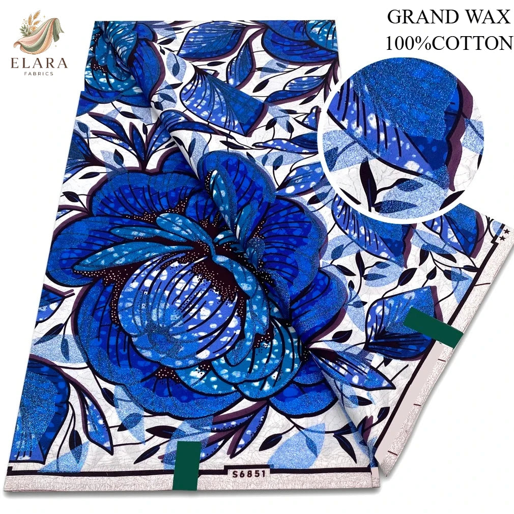 Blue and white floral wax print fabric featuring large blue flowers and leafy patterns