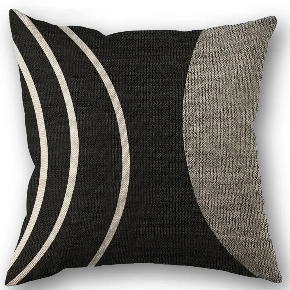 Abstract geometric pillow cover featuring black and gray stripes on a square cushion.