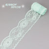 A roll of light mint green decorative lace ribbon for crafting or decoration.