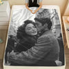 A personalized photo blanket featuring a black and white portrait of a couple embracing.