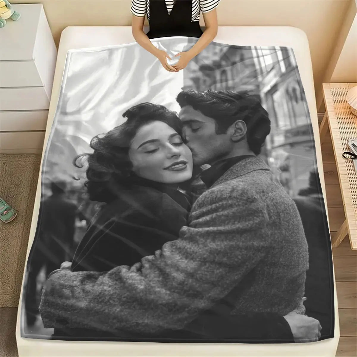A personalized photo blanket featuring a black and white portrait of a couple embracing.