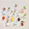 A collection of small ceramic landscape items including vases, pots, and decorative pieces in various colors and textures.