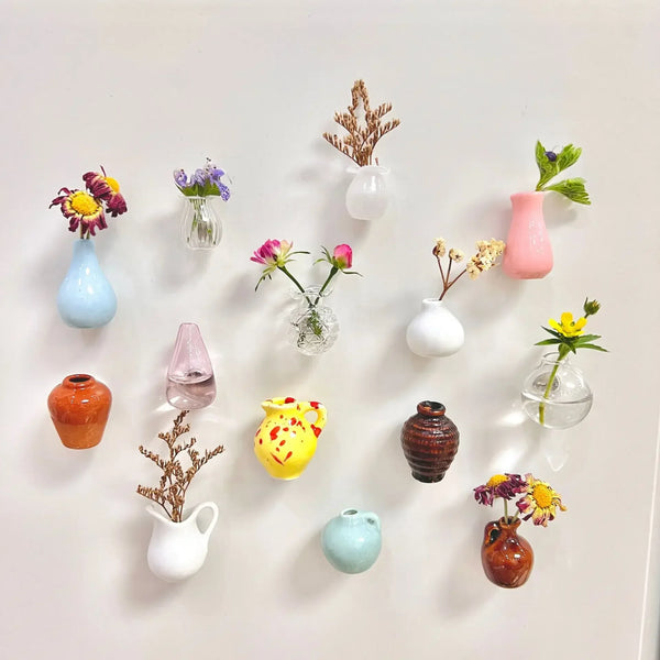 A collection of mini ceramic landscape fridge magnets featuring various colors and floral designs.