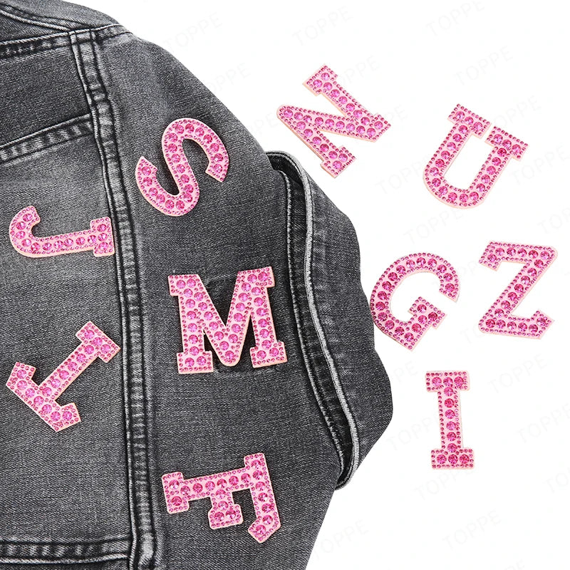 Gray denim jacket featuring pink rhinestone letter patches for DIY