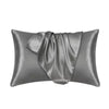 A smooth, gray silky satin pillowcase folded and displayed.