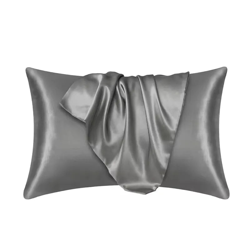 A smooth, gray silky satin pillowcase folded and displayed.