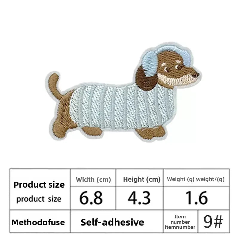 A light blue and brown embroidered patch of a dog lying down.