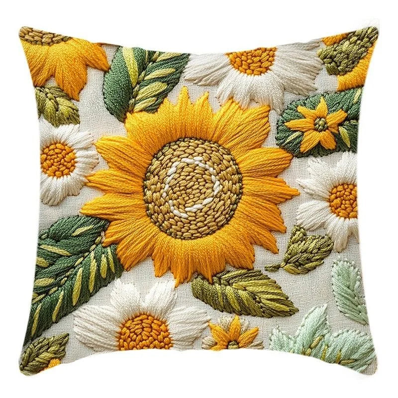 A decorative cushion pillow cover featuring embroidered or textured sunflowers in shades of yellow, orange, and green.