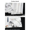 Close-up of white linen placemats featuring delicate floral and botanical patterns.