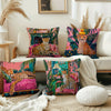 A decorative cushion cover featuring a cheetah print and tropical plant design on a light-colored sofa.