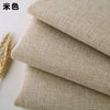 Stack of beige coarse linen and cotton fabric rolls