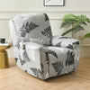 A gray recliner chair covered in a floral print slipcover featuring dark green leaves and light accents.