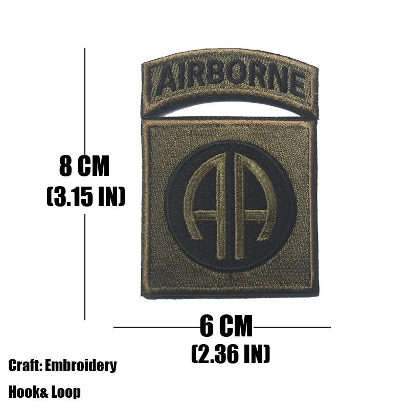 A dark olive embroidered tactical patch with the letters AA on a black background and hook-and-loop backing.