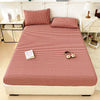 A red and white checkered fitted sheet displayed on a bed with matching pillows and surrounding furniture.