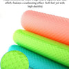 Three rolled silicone anti-skid fridge liners in pink, orange, and green colors.