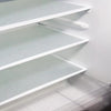 White plastic shelf liners are installed in a refrigerator, showing multiple levels of storage.