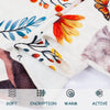 Close-up of a white flannel blanket featuring floral and botanical patterns in orange, blue, and brown tones.