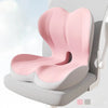 A pink ergonomic memory foam lumbar seat cushion is shown in a light gray chair setting.