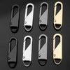 A set of eight metal zipper slider pullers in various finishes and sizes.