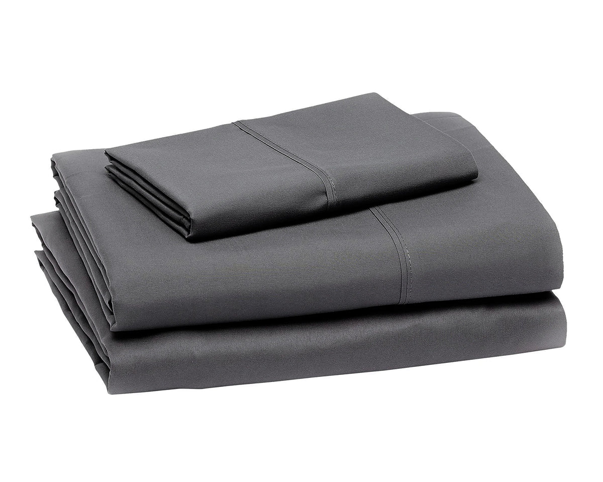 A stack of four dark gray microfiber flat fitted sheets.