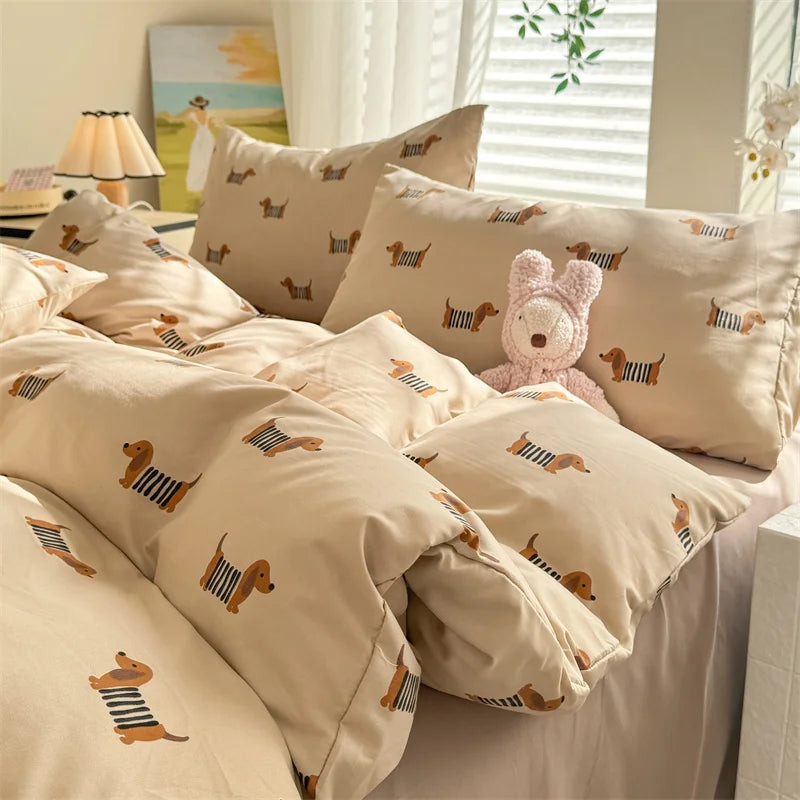 A beige duvet set featuring a cute dog print on pillows and bedding.