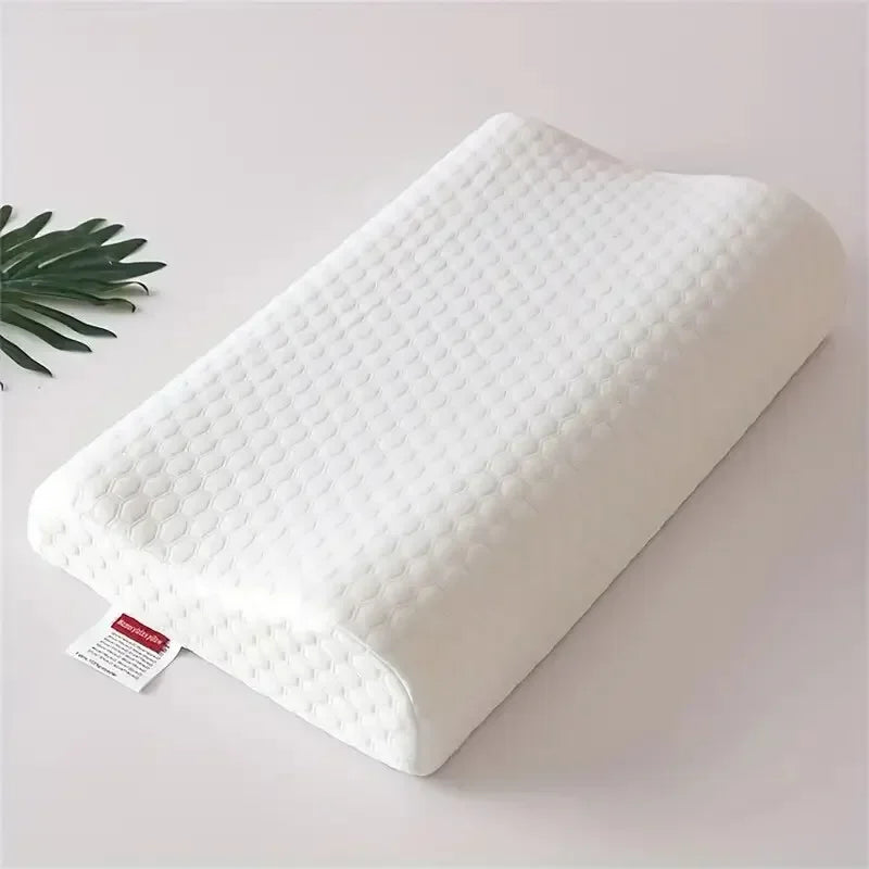 White memory foam anti-snoring pillow lying on a light surface.