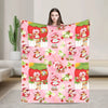 A pink strawberry shortcake plush throw blanket featuring characters and fruit designs.