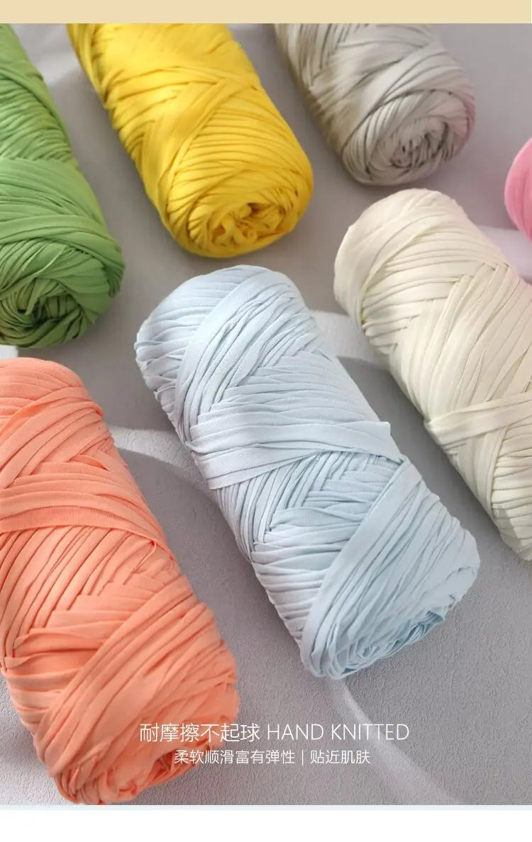 Hand knitted elastic yarn in various colors including yellow, green, orange, and white rolls