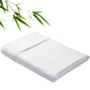 White bamboo fiber flat bed sheet folded neatly with green leaves in the background