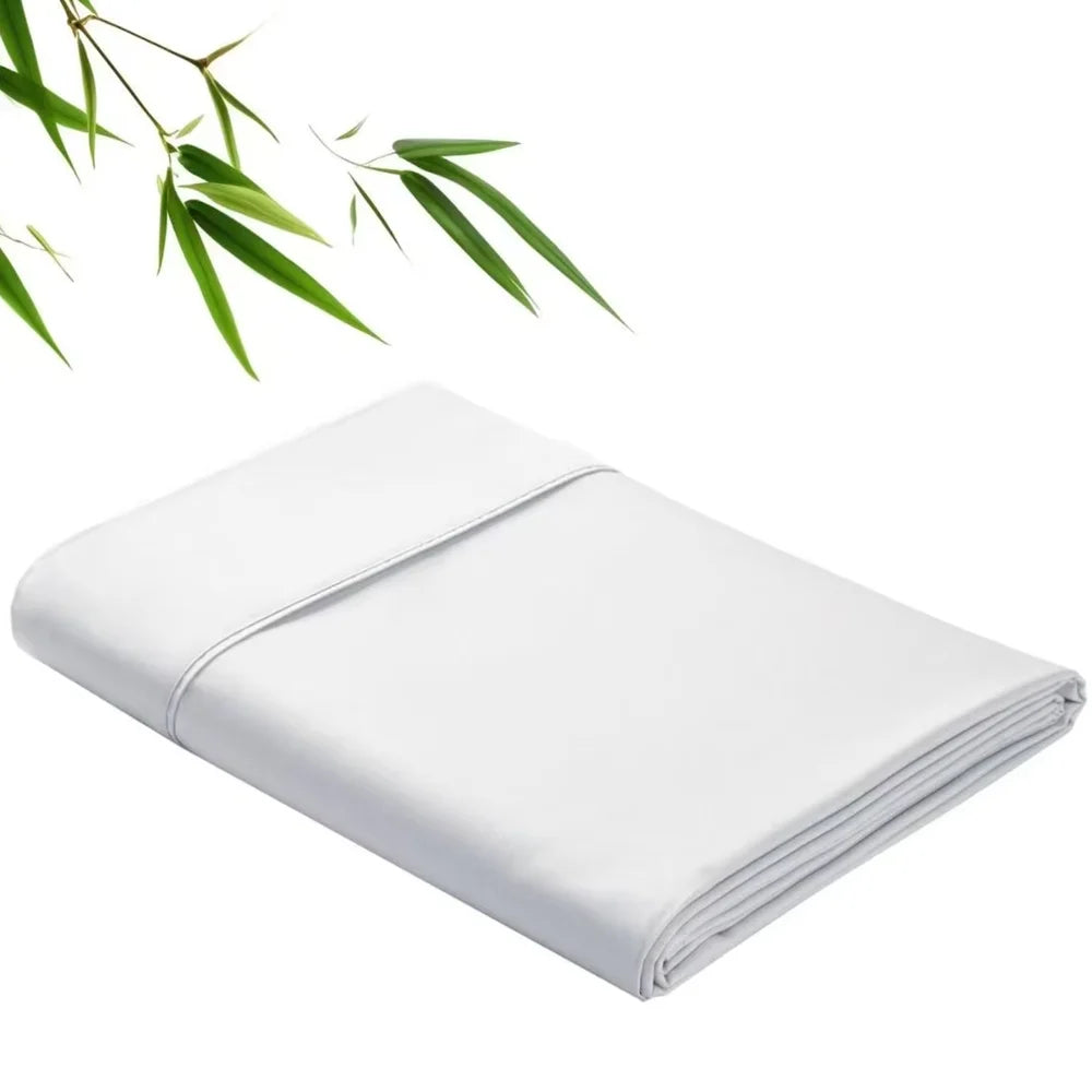 White bamboo fiber flat bed sheet folded neatly with green leaves in the background