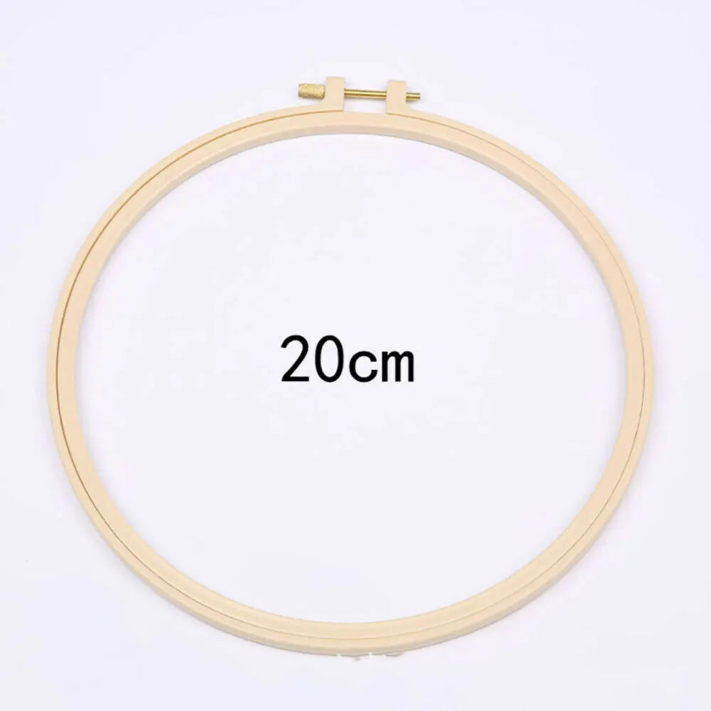A round embroidery hoop with a 20cm diameter, used for floral cross stitch embroidery.