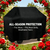 Black all-season protection grill cover with breathable fabric displayed in a garden setting.