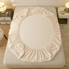 A beige plush rabbit winter fitted bed sheet set displayed on a light-colored bed.