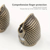 A close-up view of a bronze sewing thimble and needle protector with a dense round concave design.