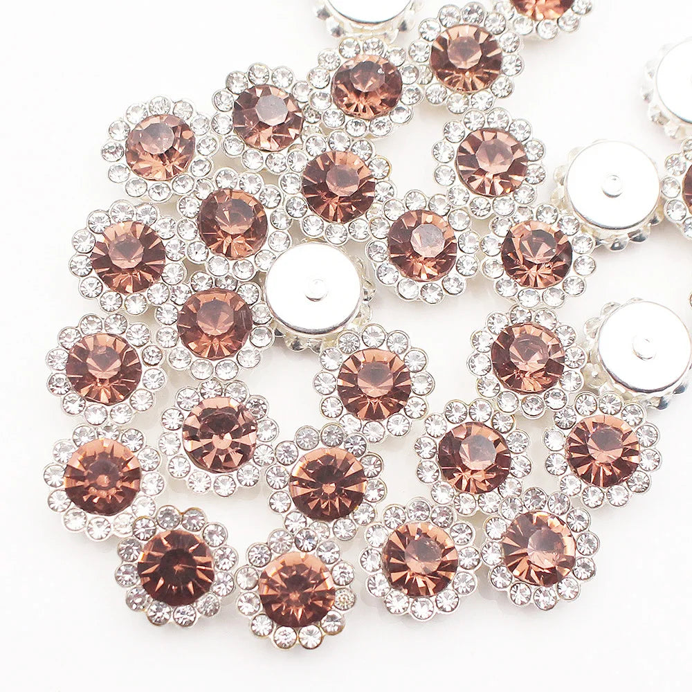 A close-up of sunflower crystal rhinestone sew-on buttons in shades of rose gold and clear silver.