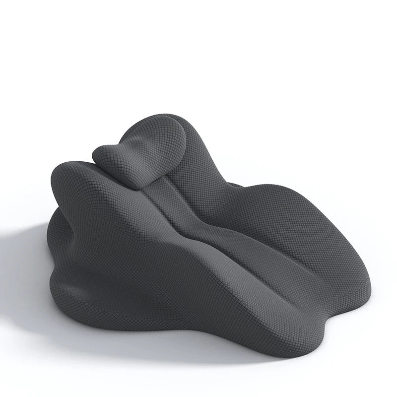 A dark gray ergonomic memory foam reading pillow shaped for back and head support.