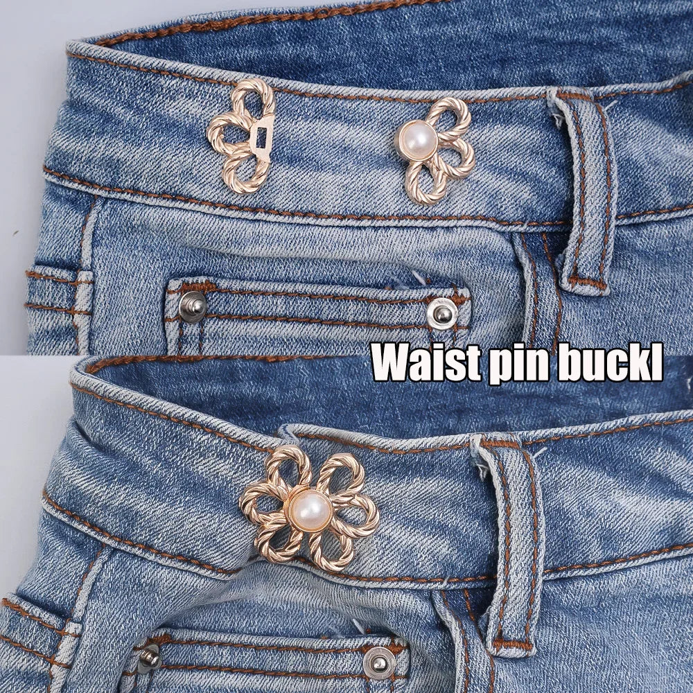 Close-up of a denim jean waistband featuring decorative metal waist pin buckles