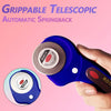 A hand holds a blue telescopic automatic springback rotary cutter with a 45mm cutter and cutting mat.